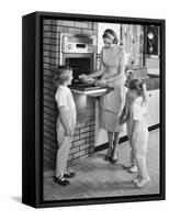 1950s MOTHER AND THREE DAUGHTERS STANDING AROUND OVEN IN KITCHEN BAKING PIE-Panoramic Images-Framed Stretched Canvas