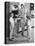 1950s MOTHER AND THREE DAUGHTERS STANDING AROUND OVEN IN KITCHEN BAKING PIE-Panoramic Images-Stretched Canvas