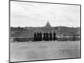 1950s Rome,, Italy Back View of Student Priests Lined Up by Wall Overlooking City with View-null-Mounted Photographic Print