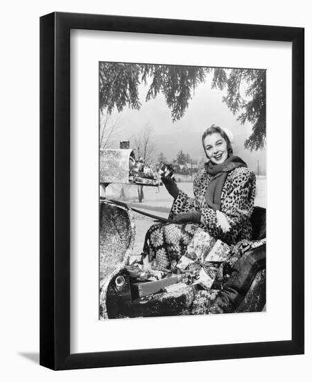 1950s SMILING WOMAN LOOKING AT CAMERA RIDING IN SLEIGH WEARING LEOPARD SKIN FUR COAT AT MAILBOX...-Panoramic Images-Framed Photographic Print