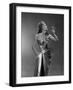 1950s WOMAN WEARING METALLIC EVENING GOWN HOLDING UP WINE GLASS PROFILE-Panoramic Images-Framed Photographic Print