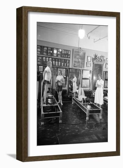 1951: Roberta Peters Working Out with Joseph Pilates and Others in a Studio, New York, NY-Michael Rougier-Framed Premium Photographic Print