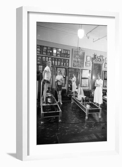 1951: Roberta Peters Working Out with Joseph Pilates and Others in a Studio, New York, NY-Michael Rougier-Framed Premium Photographic Print