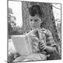1960s 1970s BOY LEANING AGAINST TREE READING BOOK-Panoramic Images-Mounted Photographic Print