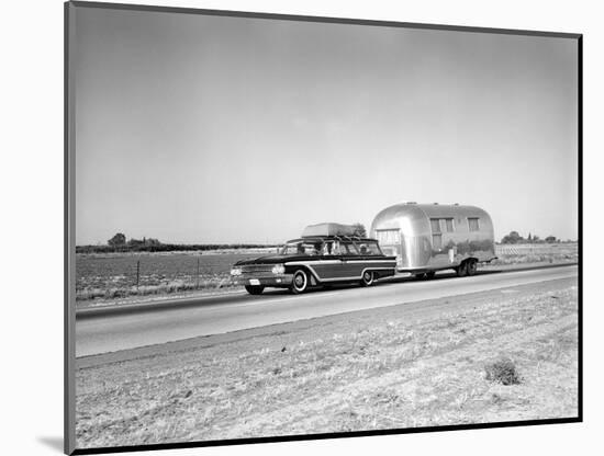 1960s-1970s Family Station Wagon and Camping Trailer Driving on Country Highway on Vacation-null-Mounted Photographic Print