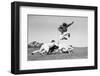 1960s FOOTBALL PLAYER JUMPING OVER BLOCKED PLAYERS-H. Armstrong Roberts-Framed Photographic Print