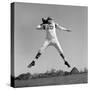 1960s QUARTERBACK JUMPING AND THROWING PASS FOOTBALL-H. Armstrong Roberts-Stretched Canvas