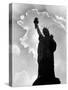 1960s Silhouette of Statue of Liberty with Sun Ray Clouds Behind-null-Stretched Canvas