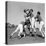 1960s SIX MEN PLAYING FOOTBALL GROUP TACKLE-H. Armstrong Roberts-Stretched Canvas
