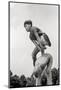 1970s TWO BOYS PLAYING LEAPFROG ONE VAULTING OVER THE OTHER-H. Armstrong Roberts-Mounted Photographic Print