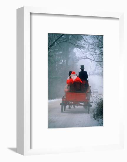 1990s ANONYMOUS SANTA CLAUS IN HORSE-DRAWN WAGON SNOWY DIRT ROAD REAR VIEW-Panoramic Images-Framed Photographic Print