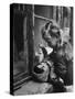 3 Year Old Child Playing with Doll on Window Sill of Apartment-Stan Wayman-Stretched Canvas