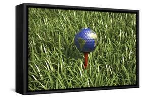 3D Rendering of an Earth Golf Ball on Tee in the Grass-null-Framed Stretched Canvas