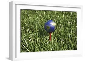 3D Rendering of an Earth Golf Ball on Tee in the Grass-null-Framed Art Print