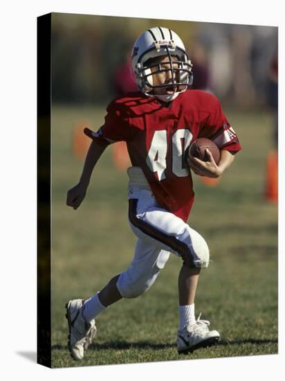 8 Year Old Boy Running with the Football-null-Stretched Canvas