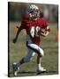 8 Year Old Boy Running with the Football-null-Stretched Canvas