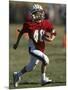 8 Year Old Boy Running with the Football-null-Mounted Photographic Print