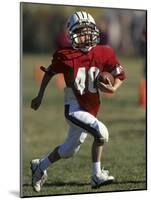 8 Year Old Boy Running with the Football-null-Mounted Photographic Print