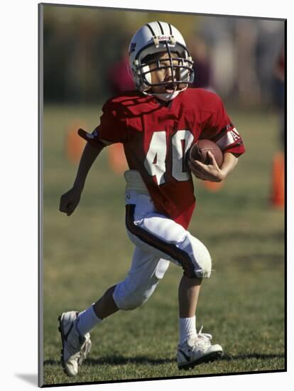 8 Year Old Boy Running with the Football-null-Mounted Photographic Print