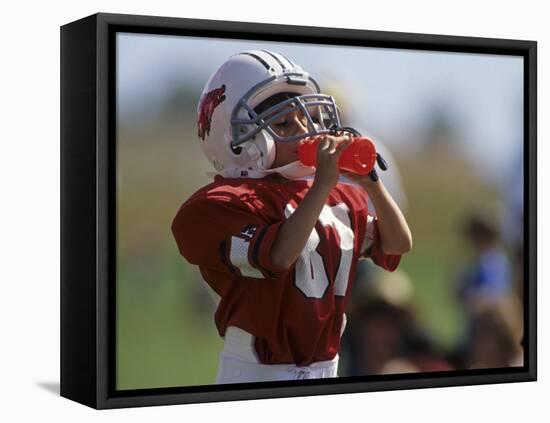 8 Year Old Boy Taking a Drink During a Football Game-null-Framed Stretched Canvas