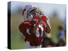 8 Year Old Boy Taking a Drink During a Football Game-null-Stretched Canvas