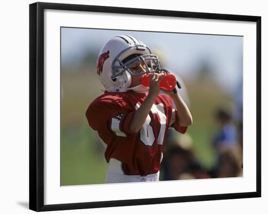 8 Year Old Boy Taking a Drink During a Football Game-null-Framed Photographic Print