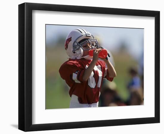 8 Year Old Boy Taking a Drink During a Football Game-null-Framed Photographic Print