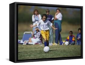 8 Year Old Girl in Action Durring Soccer Game, Lakewood, Colorado, USA-null-Framed Stretched Canvas