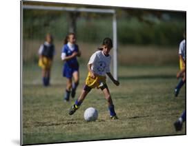 8 Year Old Girl in Action Durring Soccer Game, Lakewood, Colorado, USA-null-Mounted Photographic Print