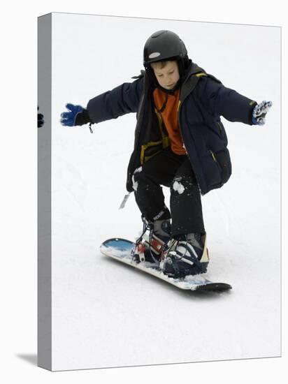 9 Year Old Boy Riding His Snowboard, New York, USA-Paul Sutton-Stretched Canvas