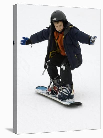 9 Year Old Boy Riding His Snowboard, New York, USA-Paul Sutton-Stretched Canvas