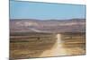 A 4X4 Car Leaves a Cloud of Dust as it Apporachs Along the Long Dusty Road to the Fish River Canyon-Alex Treadway-Mounted Photographic Print