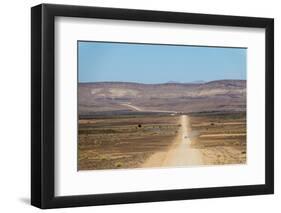 A 4X4 Car Leaves a Cloud of Dust as it Apporachs Along the Long Dusty Road to the Fish River Canyon-Alex Treadway-Framed Premium Photographic Print