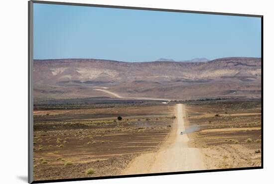 A 4X4 Car Leaves a Cloud of Dust as it Apporachs Along the Long Dusty Road to the Fish River Canyon-Alex Treadway-Mounted Photographic Print