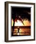 A Afternoon Runner Passes Under a Palm Tree as the Sun Sets Behind-null-Framed Photographic Print