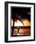 A Afternoon Runner Passes Under a Palm Tree as the Sun Sets Behind-null-Framed Photographic Print