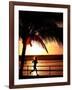 A Afternoon Runner Passes Under a Palm Tree as the Sun Sets Behind-null-Framed Photographic Print