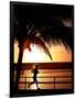 A Afternoon Runner Passes Under a Palm Tree as the Sun Sets Behind-null-Framed Photographic Print