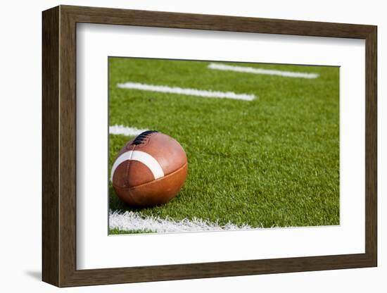 A American Football on a Green Football Field-flippo-Framed Photographic Print