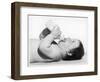 A Baby Lies on His Back Drinking Milk from His Bottle-null-Framed Photographic Print