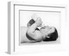 A Baby Lies on His Back Drinking Milk from His Bottle-null-Framed Photographic Print