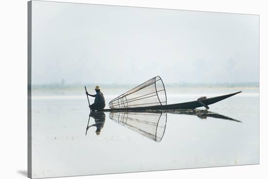 A basket fisherman on Inle Lake scans the still and shallow water for signs of life, Myanmar (Burma-Alex Treadway-Stretched Canvas