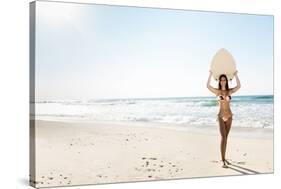 A Beautiful Surfer Girl at the Beach Holding up Her Surfboard-iko-Stretched Canvas