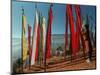 A Bhutanese Man Straightens a Prayer Flag at a Buddhist Shrine-null-Mounted Photographic Print