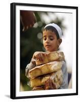 A Boy Carries Rusk as He Assists Others to Send a Consignment of Relief Supplies to Uri-null-Framed Premium Photographic Print