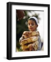 A Boy Carries Rusk as He Assists Others to Send a Consignment of Relief Supplies to Uri-null-Framed Photographic Print