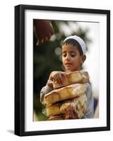A Boy Carries Rusk as He Assists Others to Send a Consignment of Relief Supplies to Uri-null-Framed Photographic Print