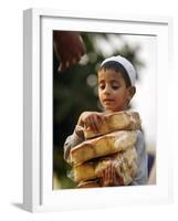 A Boy Carries Rusk as He Assists Others to Send a Consignment of Relief Supplies to Uri-null-Framed Photographic Print