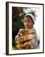 A Boy Carries Rusk as He Assists Others to Send a Consignment of Relief Supplies to Uri-null-Framed Photographic Print