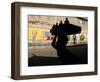 A Boy Carrying Bottles on His Head Passes by a Wall with Pictures of Haitian President Renel Preval-Ariana Cubillos-Framed Photographic Print